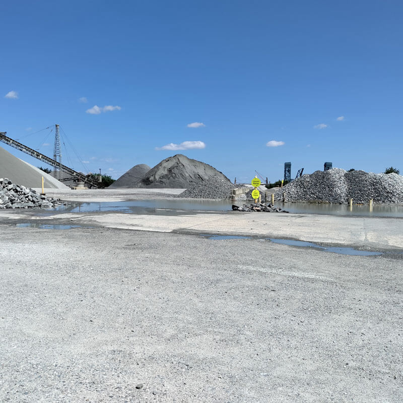 A large pile of gravel on the side of a road.